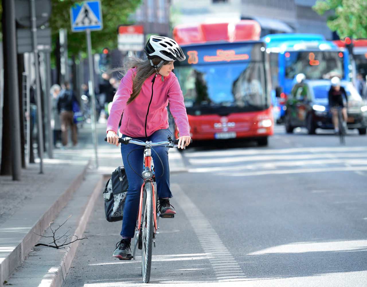 Girl and bicycle, traffic in background