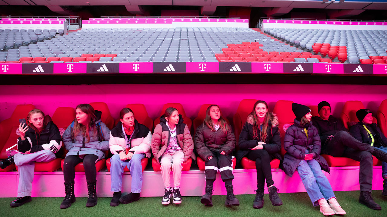 Children sitting on the stadium benches
