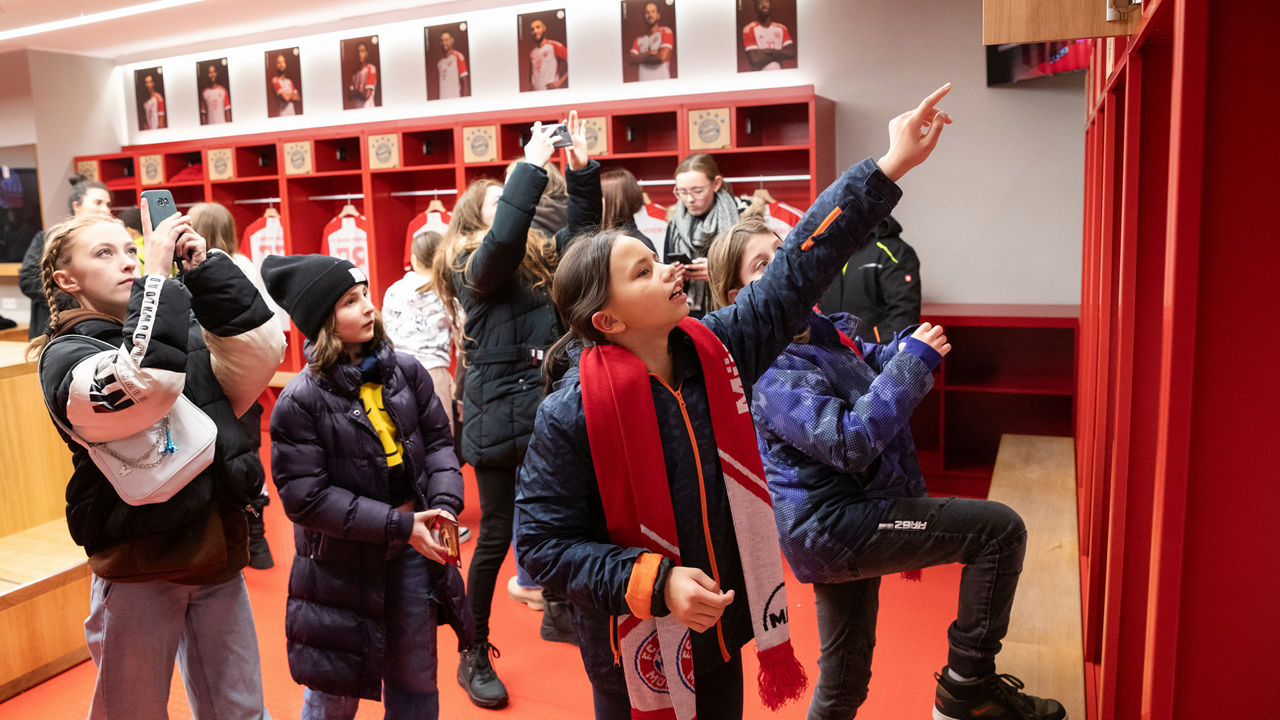 Children take photos and enjoy the team players' jerseys