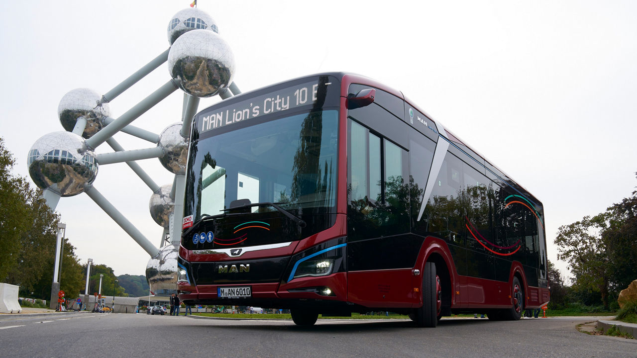 Red MAN Lion's City 10 E parked in front of the Atomium in Brussels