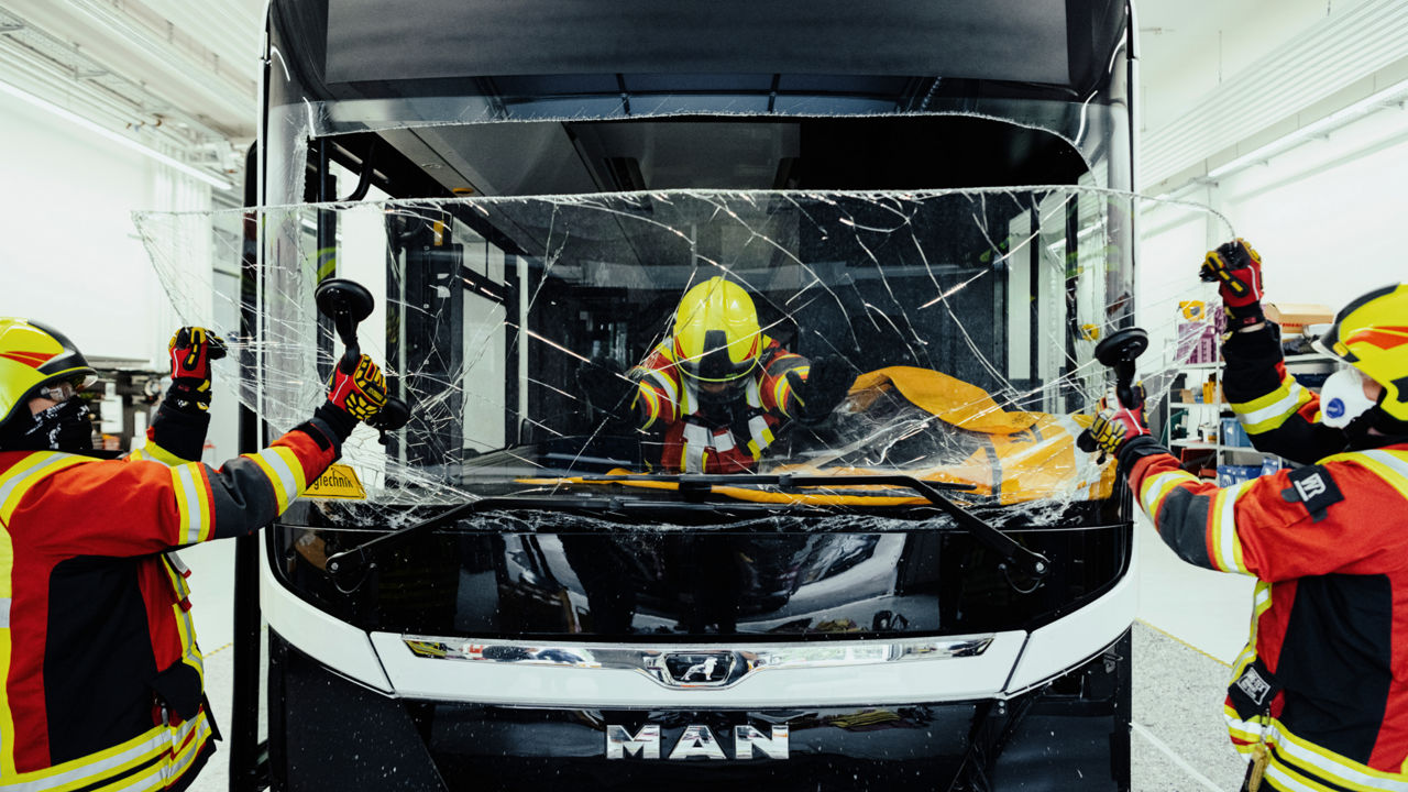 Rescue workers smash the windscreen of a MAN bus