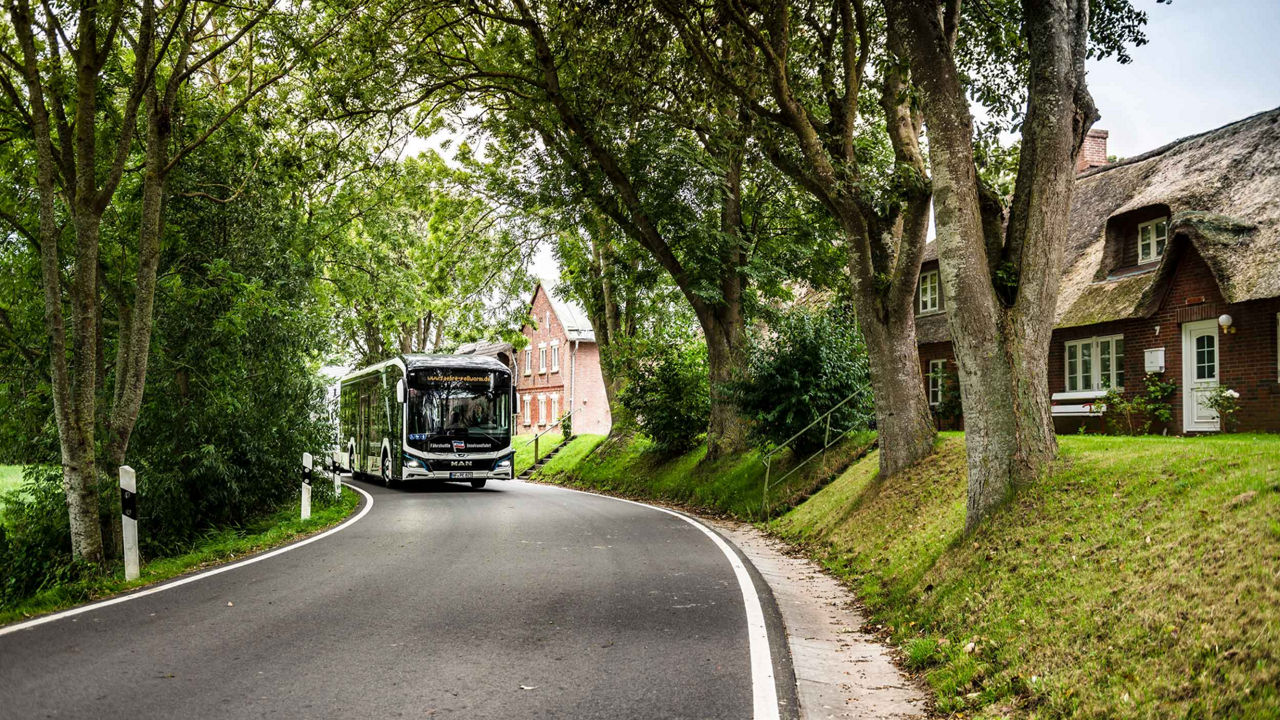 MAN Lion's City E among rural streets