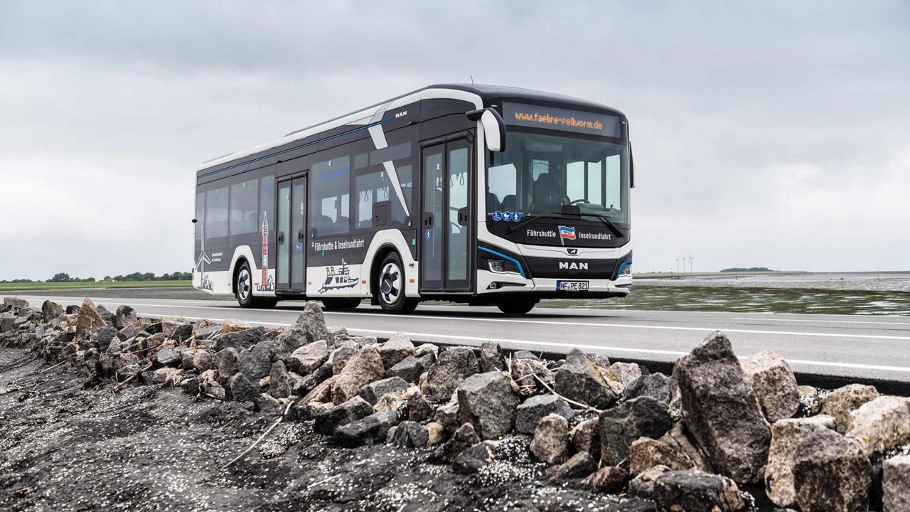 MAN Lion's City E in white with distinctive signs of the area on it, such as the lighthouse