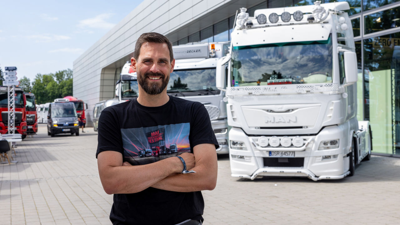 A man standing in front of a white truck