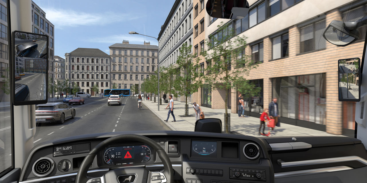 View from the driver's seat of a busy city street with pedestrians and cars.
