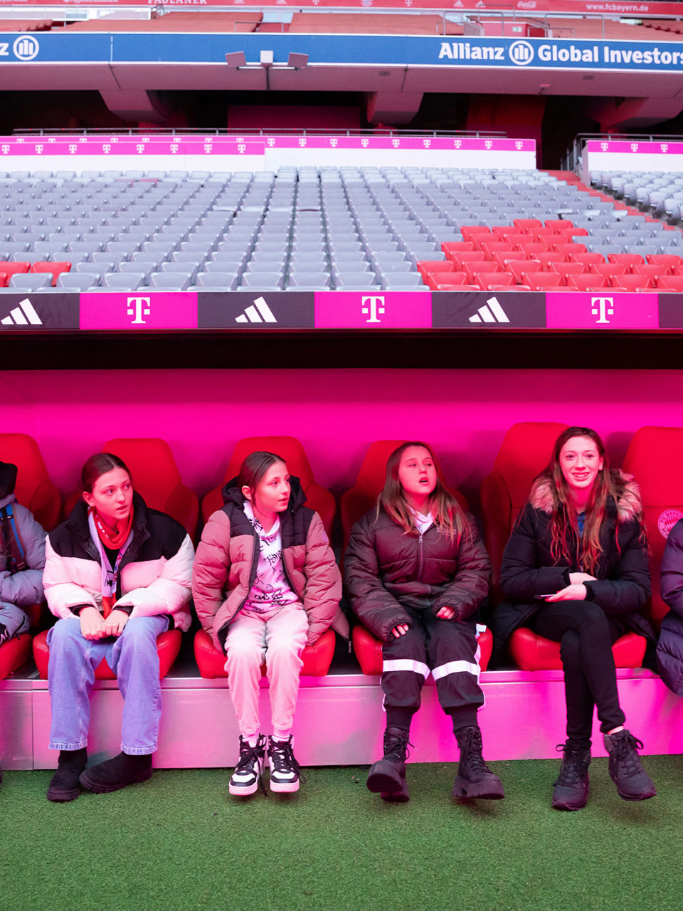 Children sitting on the stadium benches