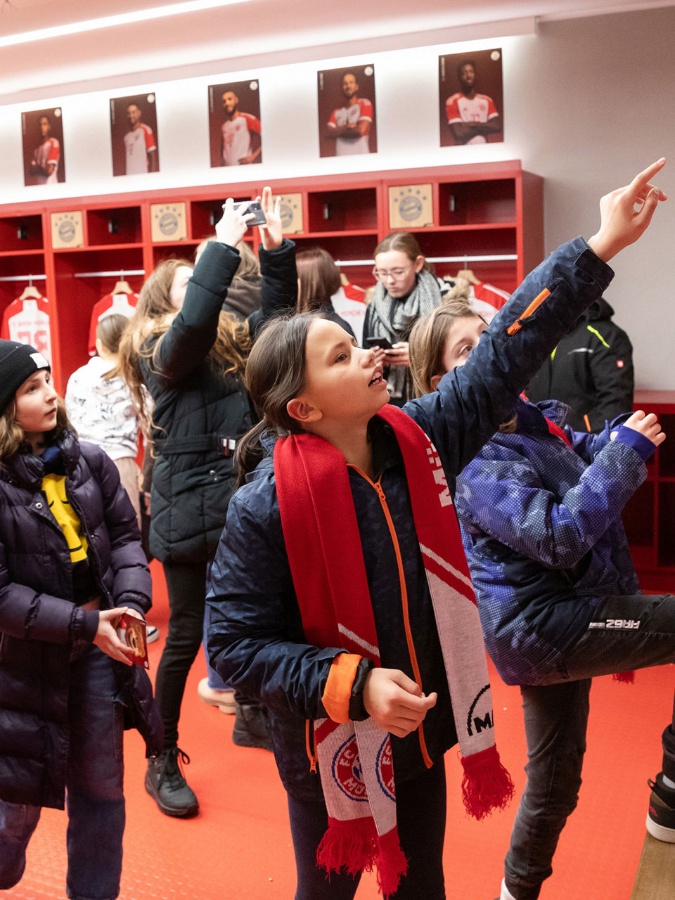 Children take photos and enjoy the team players' jerseys