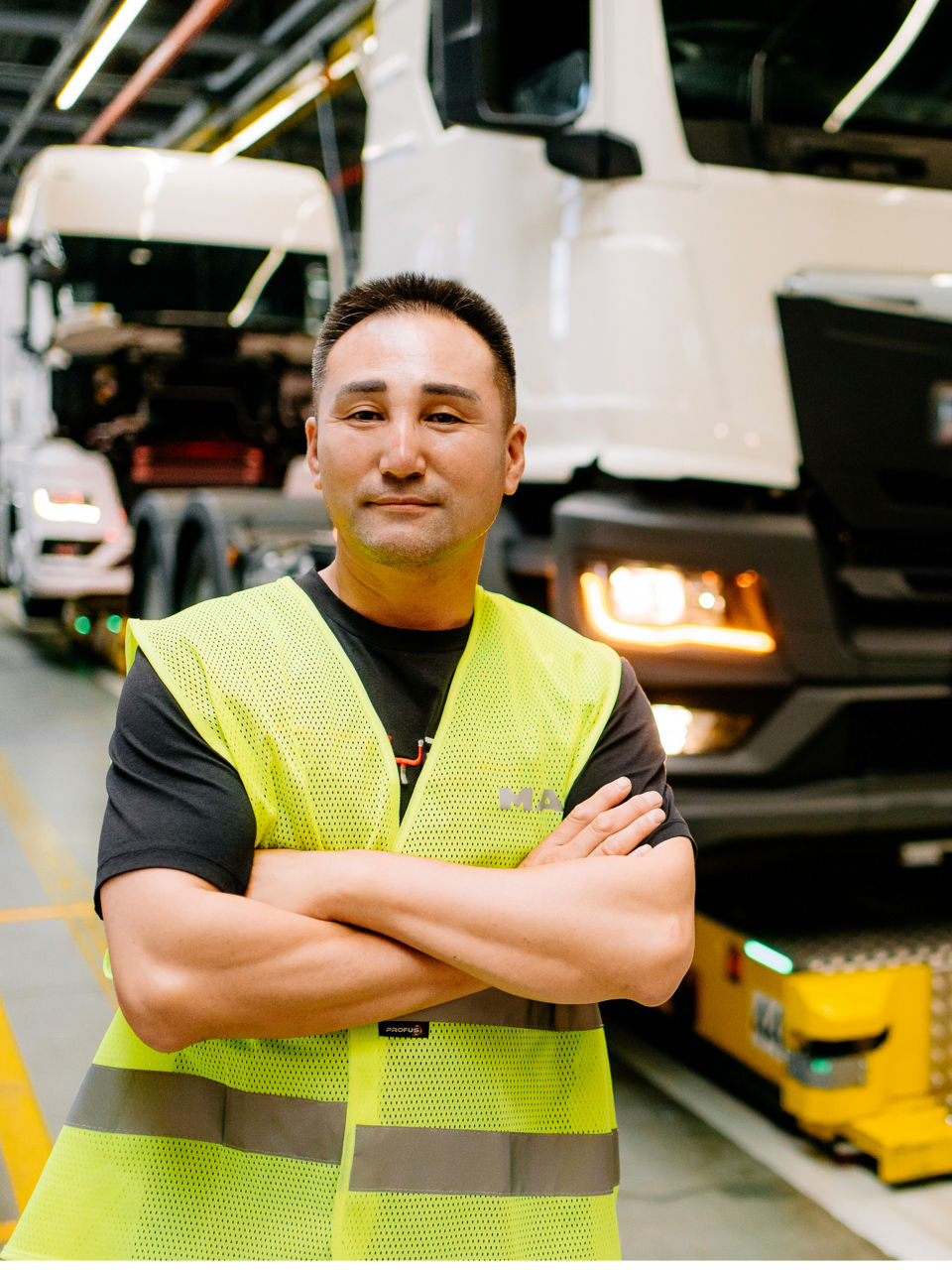 Ein Mann in einer Warnweste steht vor einem weißen Lkw