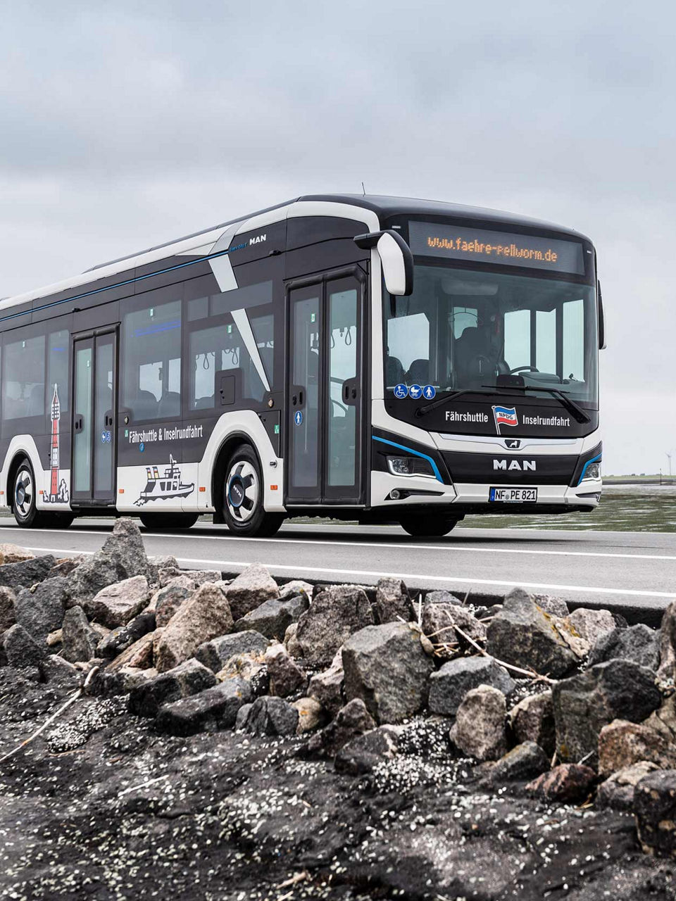 MAN Lion's City E in white with distinctive signs of the area on it, such as the lighthouse