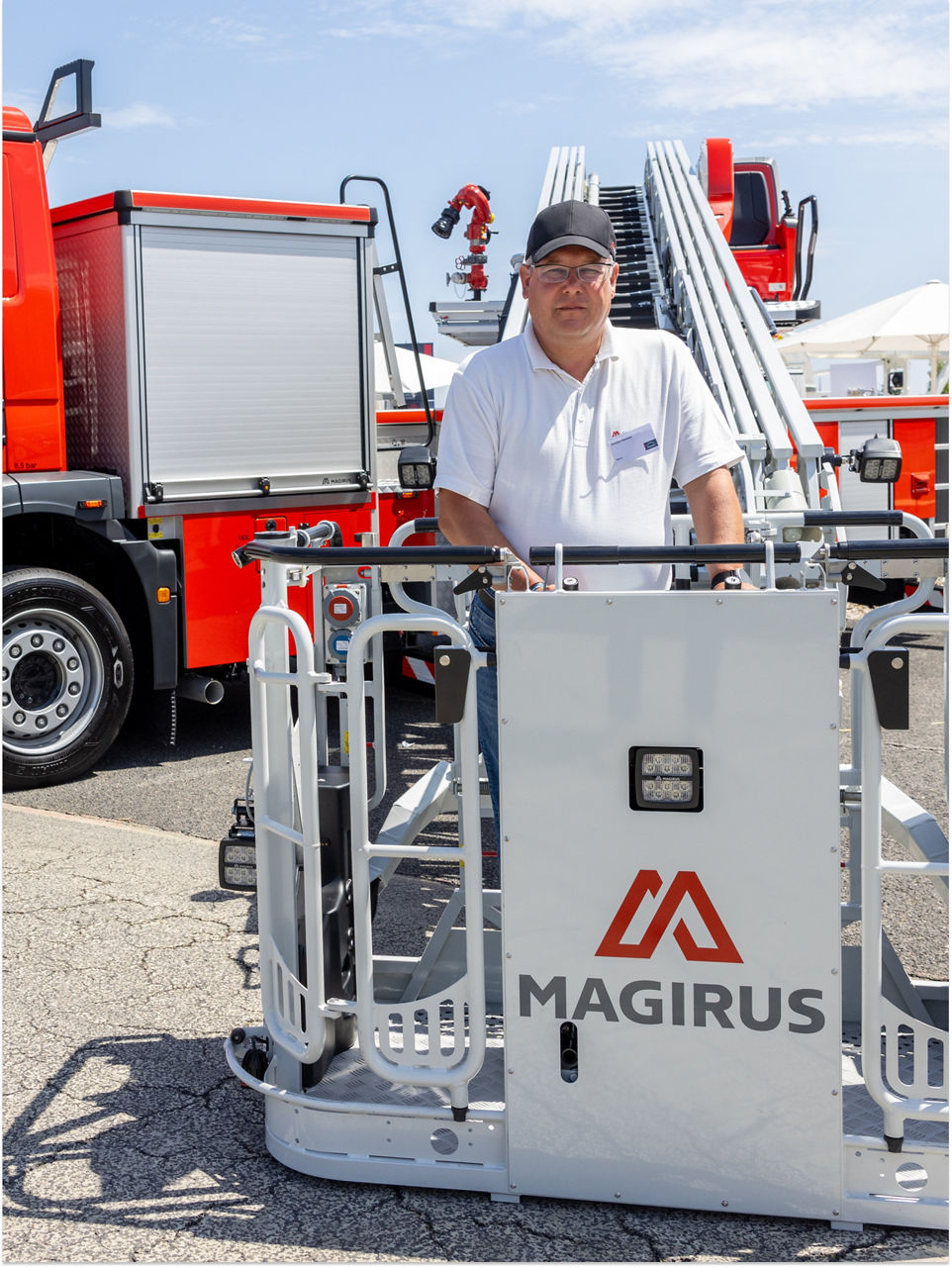 A man is standing in front of a fire engines