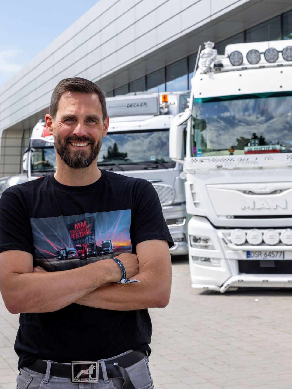A man standing in front of a white truck