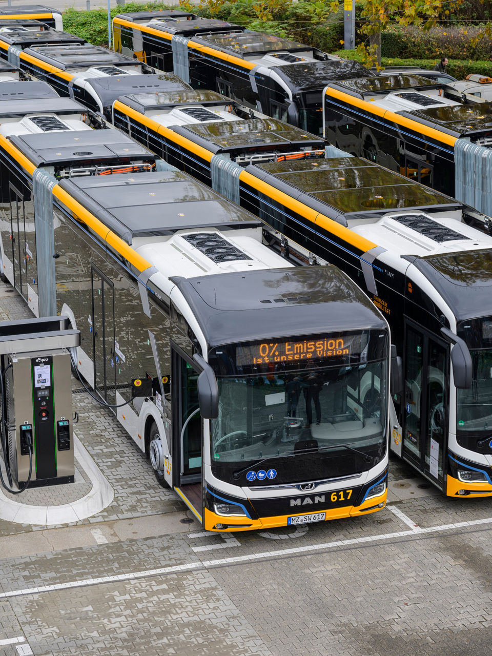 Electric buses parked at the depot are charged at the charging stations