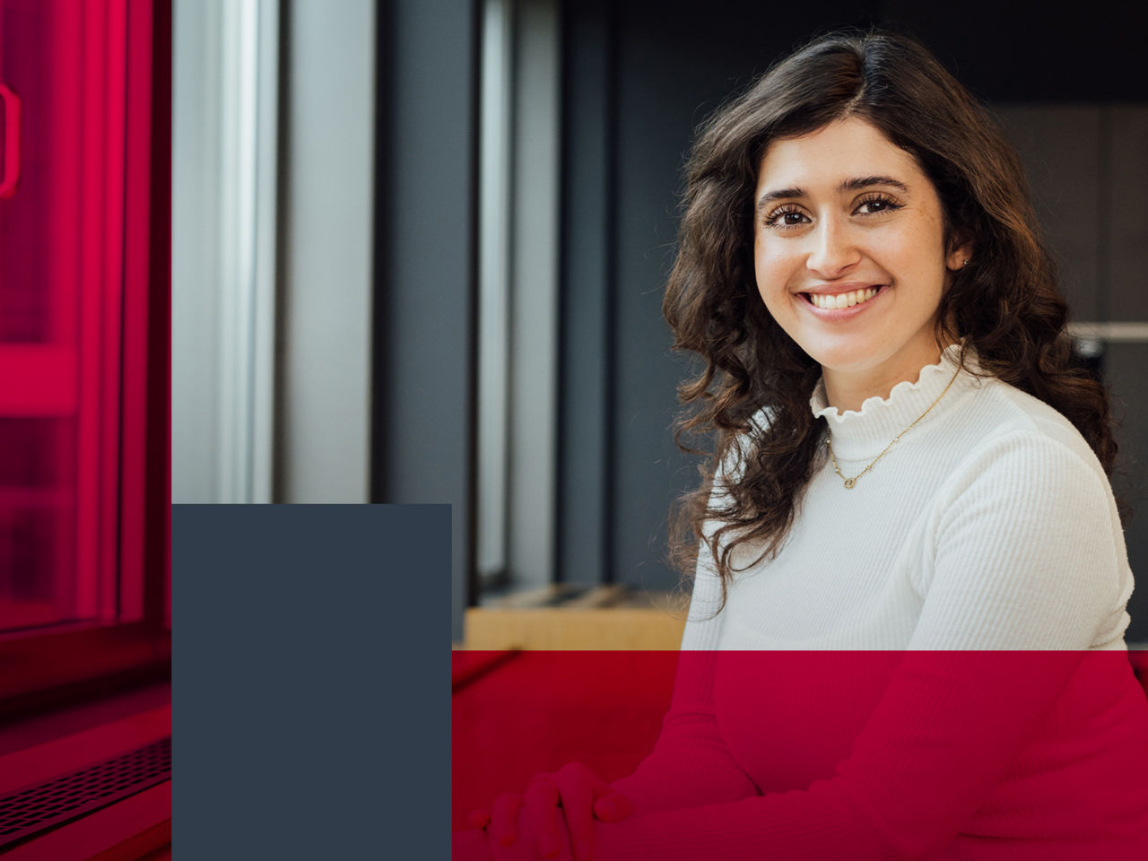 A smiling woman is looking into the camera