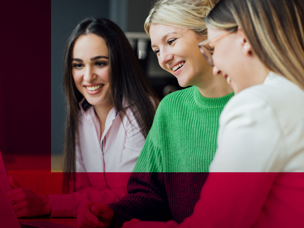 Three women are laughing and talking to each other