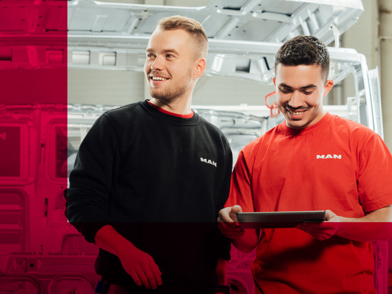 Two men are talking to each other with a tablet in their hand