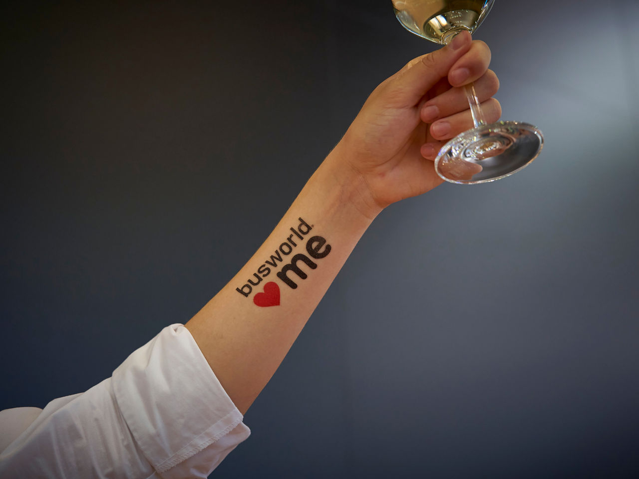 Hand holding a glass of champagne to celebrate all the sales and awards