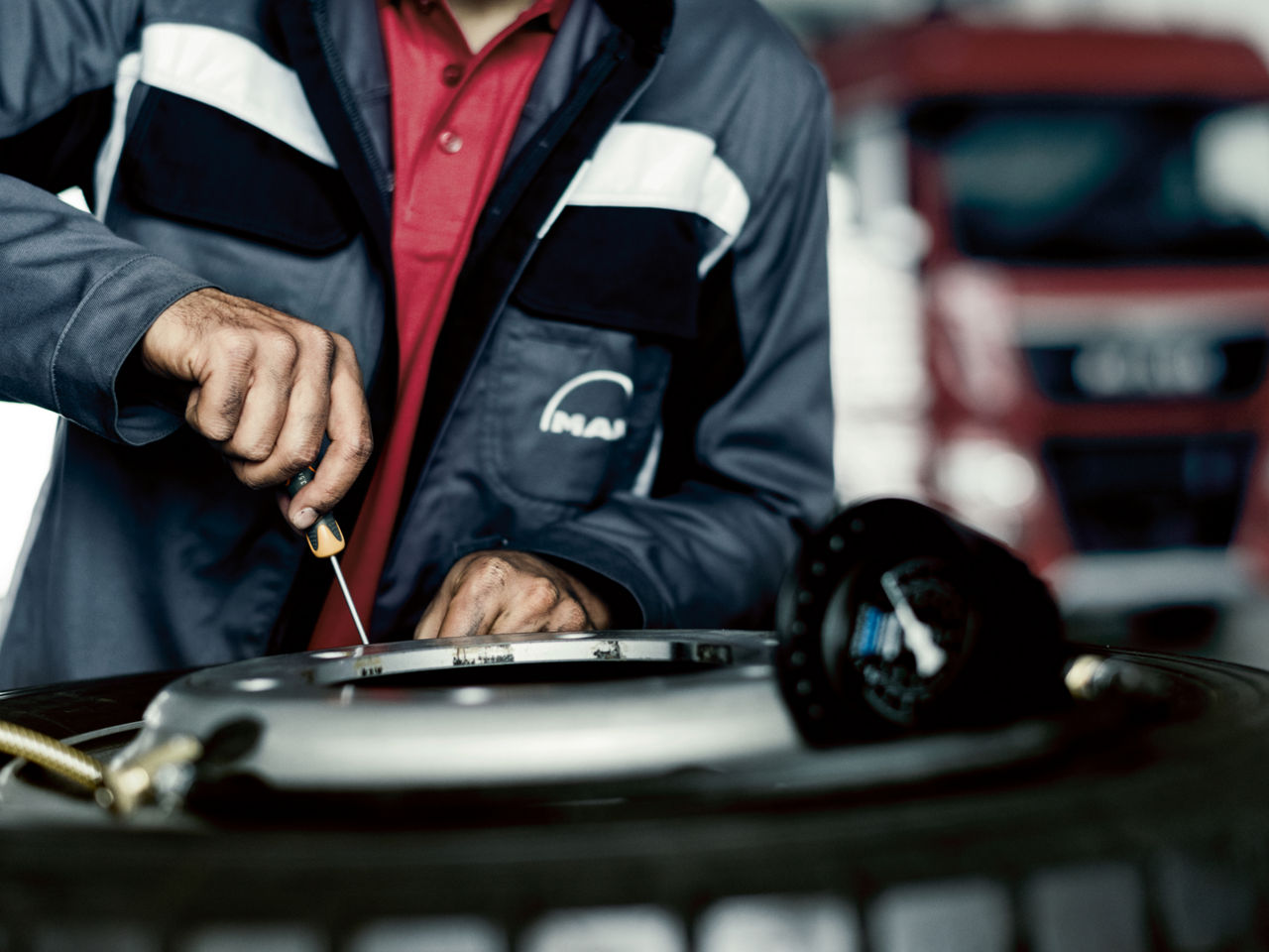 Eine junge Frau arbeitet an einer Lkw-Karrosserie