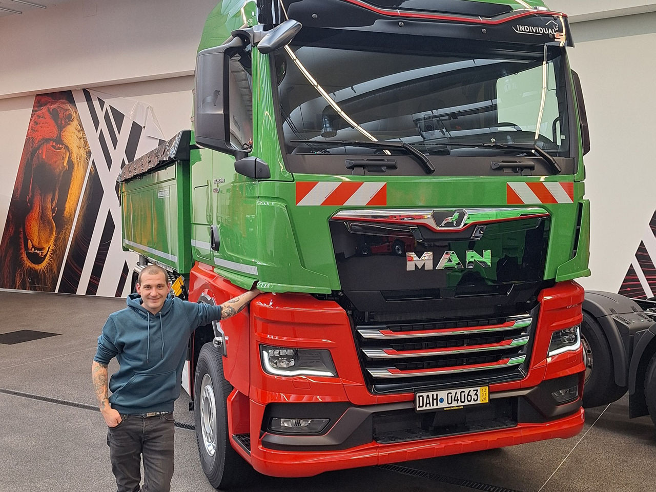 Max Gräß aus Ottweiler im Saarland holte im MAN Truck Forum München seinen neuen rot-grünen MAN TGX 28.640 ab.