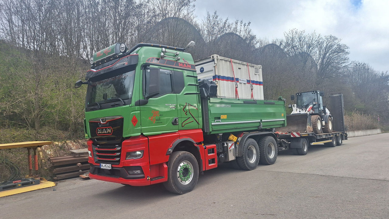 Der rot-grünen MAN TGX 28.640 und sein Anhänger sind voll beladen und bereit für die nächste Baustelle.