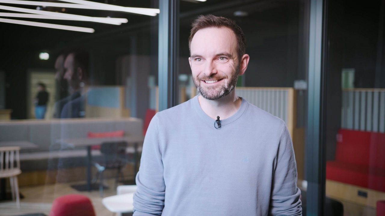 A smiling man is looking into the camera