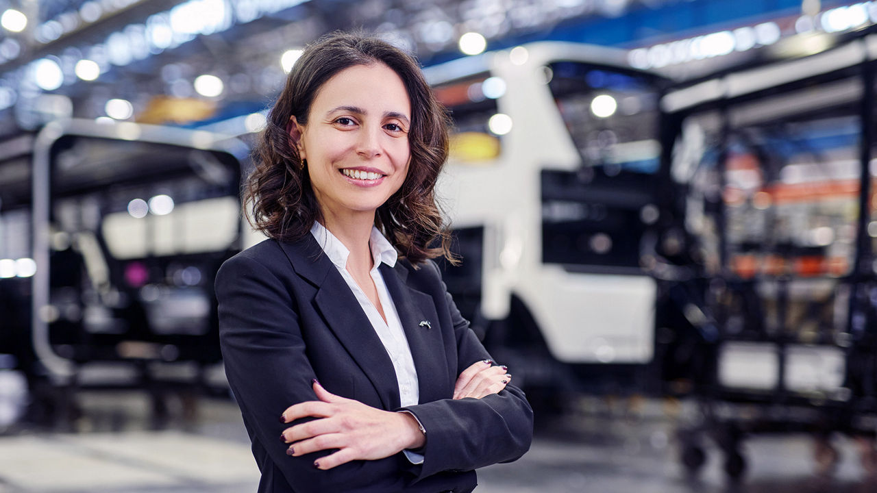 A woman standing in front of a production line.