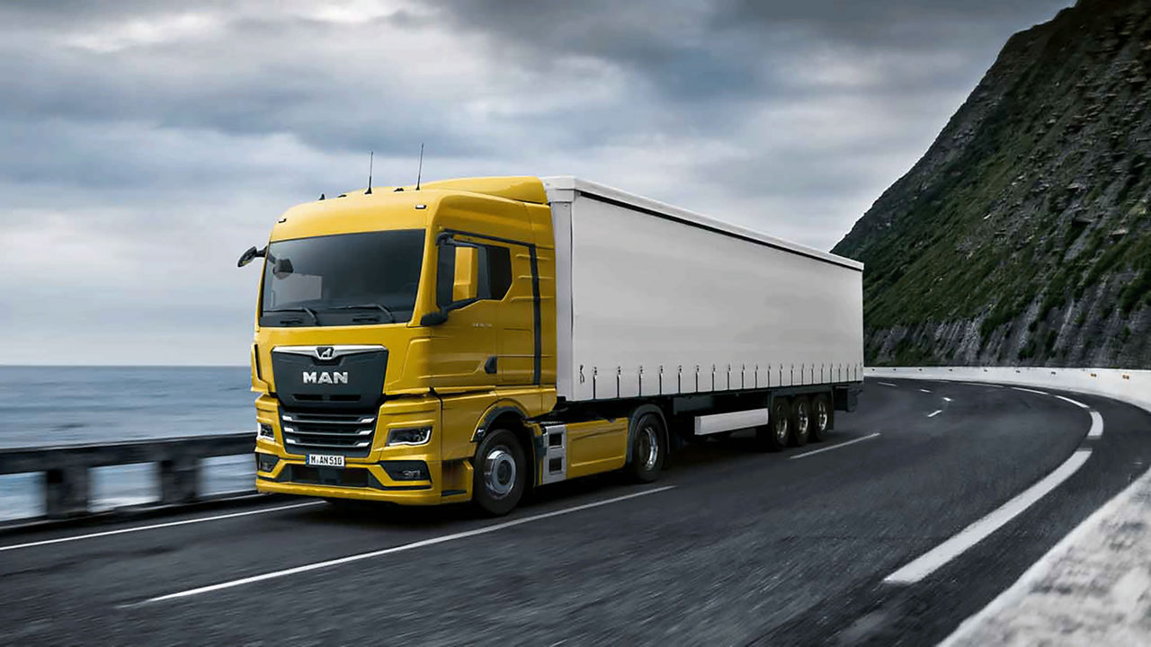 Yellow White MAN Truck drivin on the highway