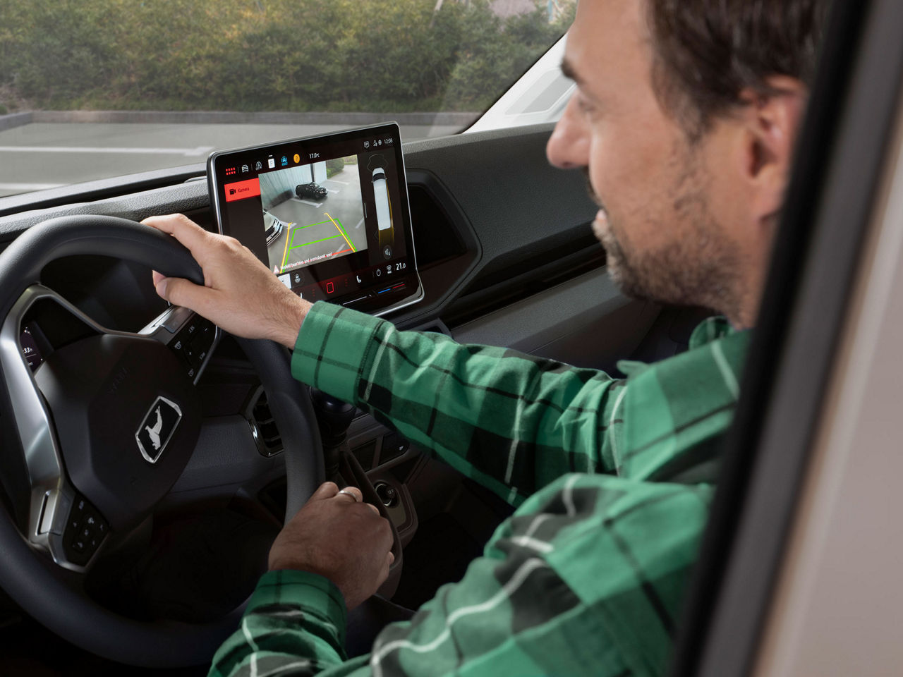 A man behind the wheel of a MAN TGE