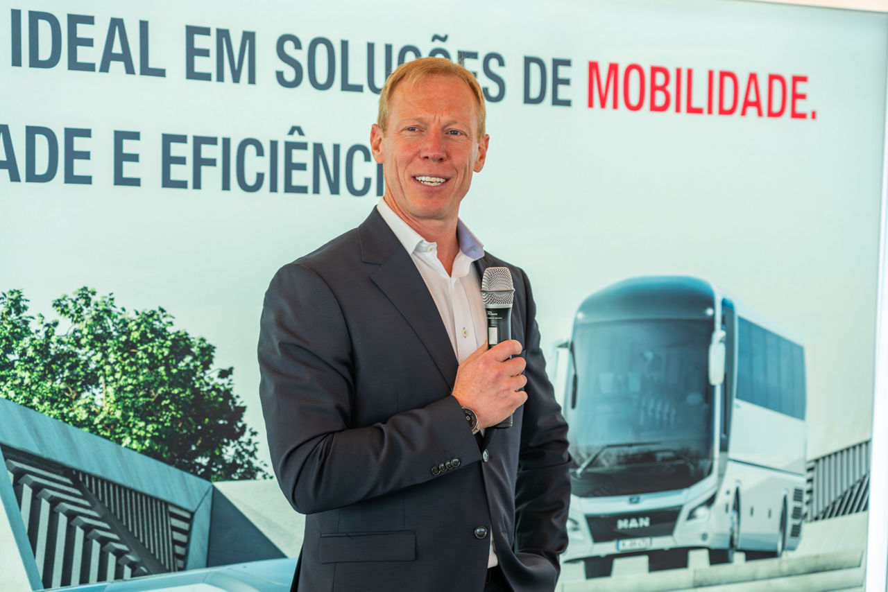 Man smiling at camera and talking to mic
