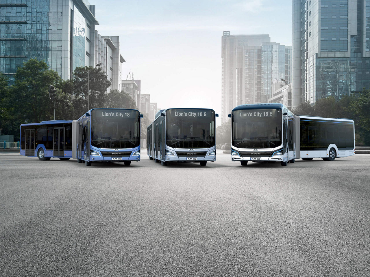 Three MAN Lion’s City buses in front of a big city skyline