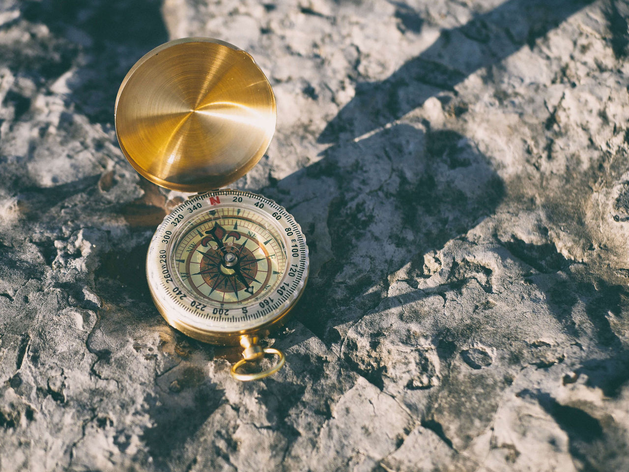 A compass lying on a rock