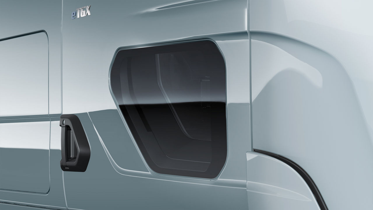 Lower door window providing a view of a female cyclist alongside the vehicle