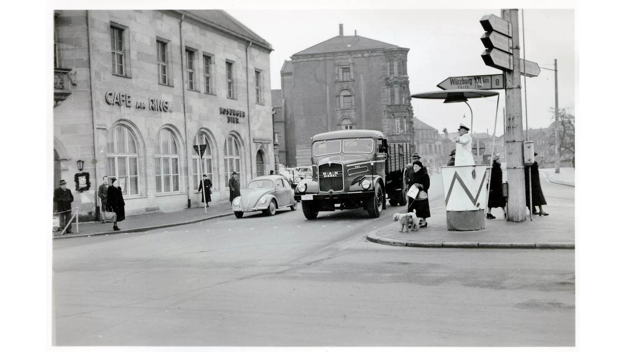 MAN F8 bonnet truck driving through a town, 1950s