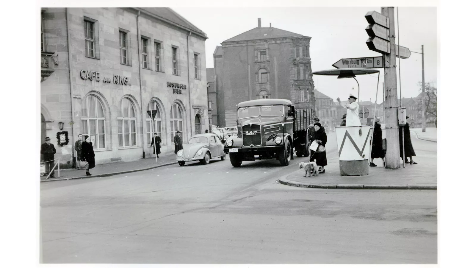 MAN F8 bonnet truck driving through a town, 1950s