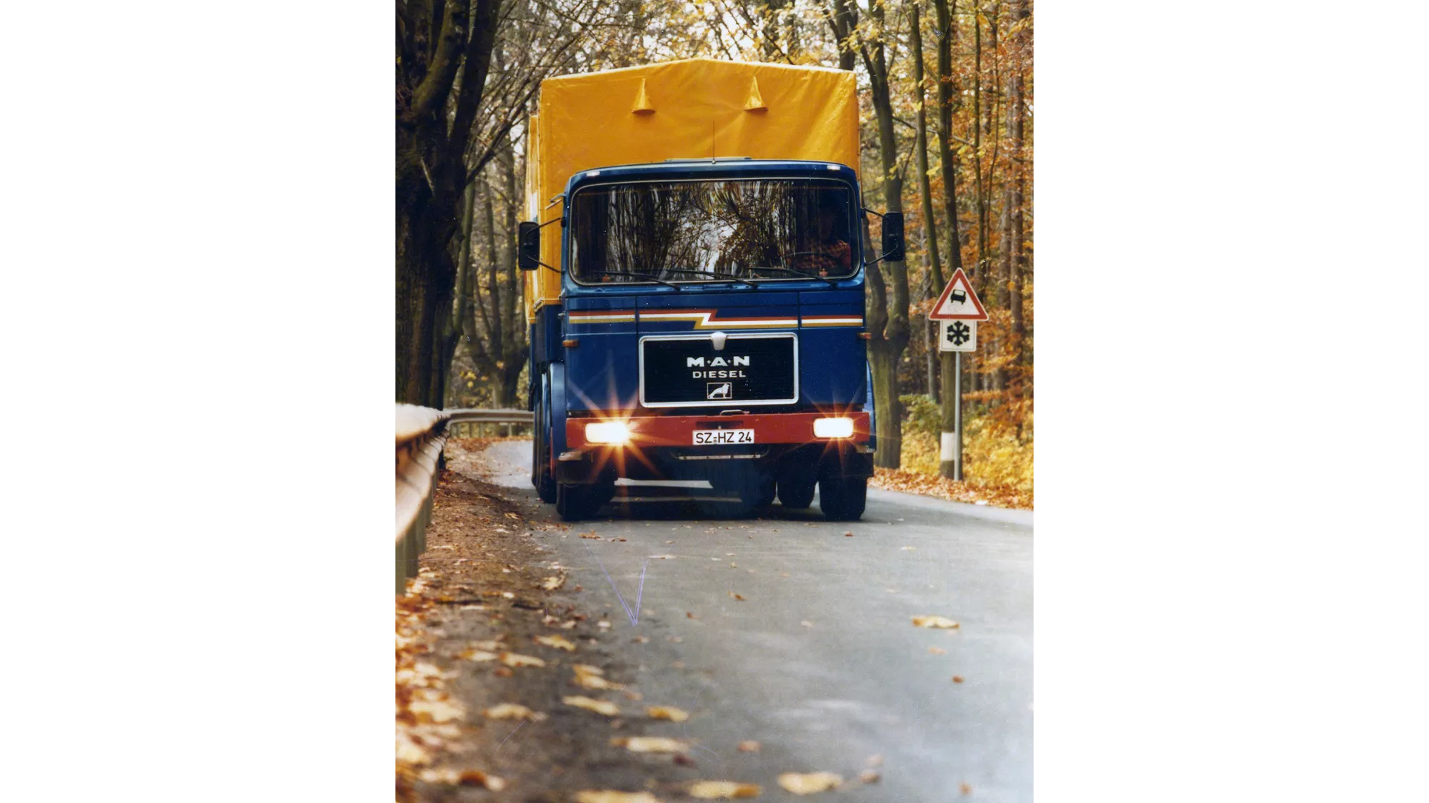A MAN 19.280 drives along a road in autumn weather
