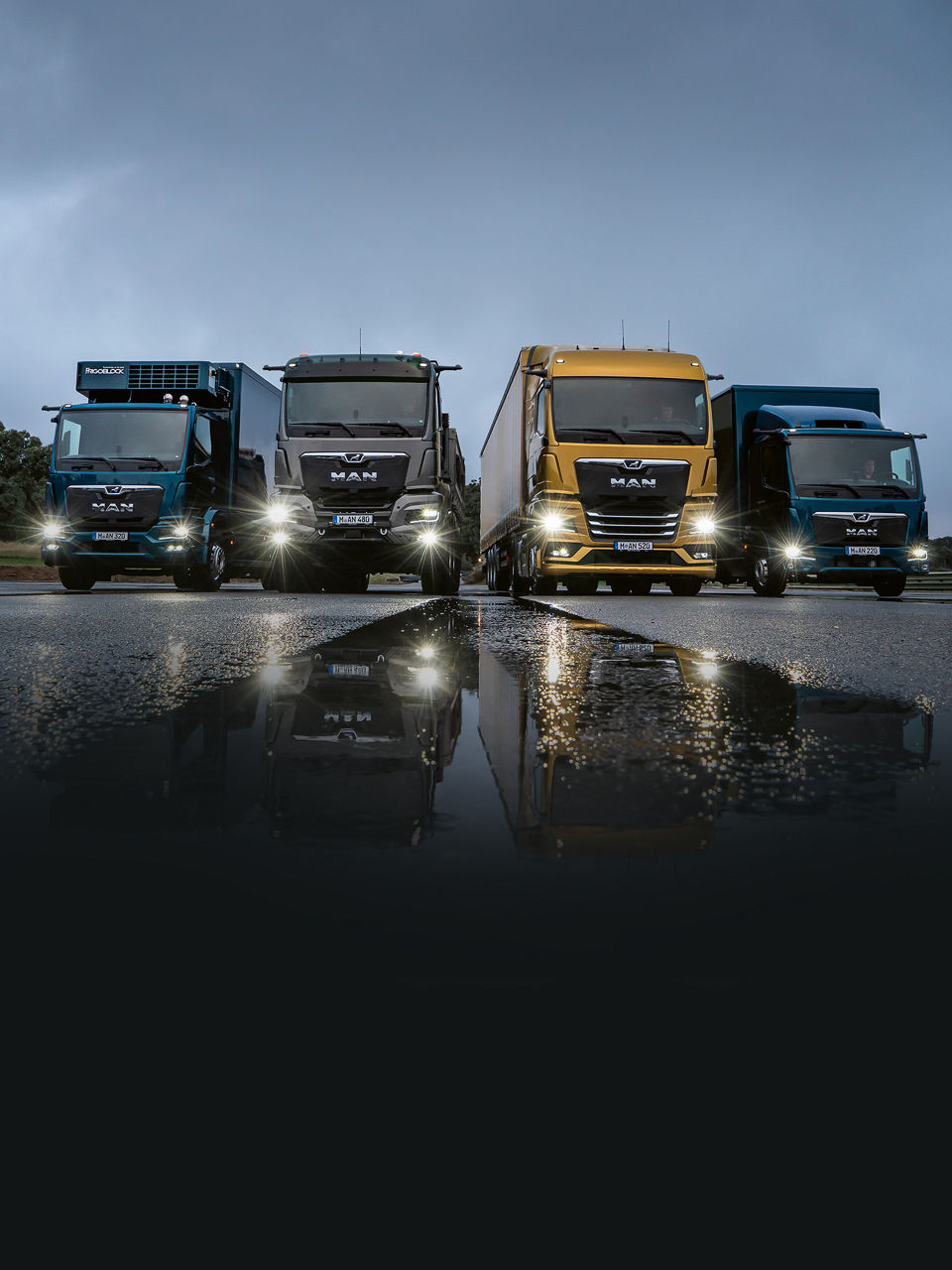 Four MAN trucks of different sizes in a row