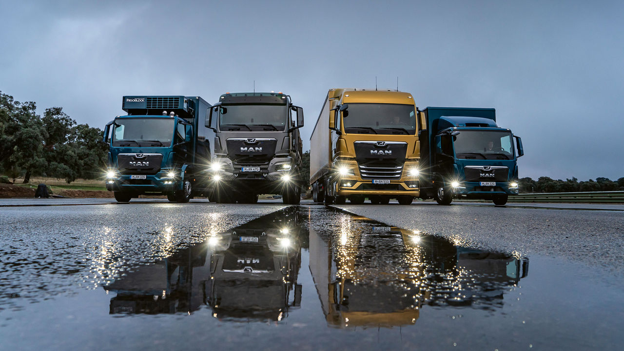Four MAN trucks of different sizes in a row
