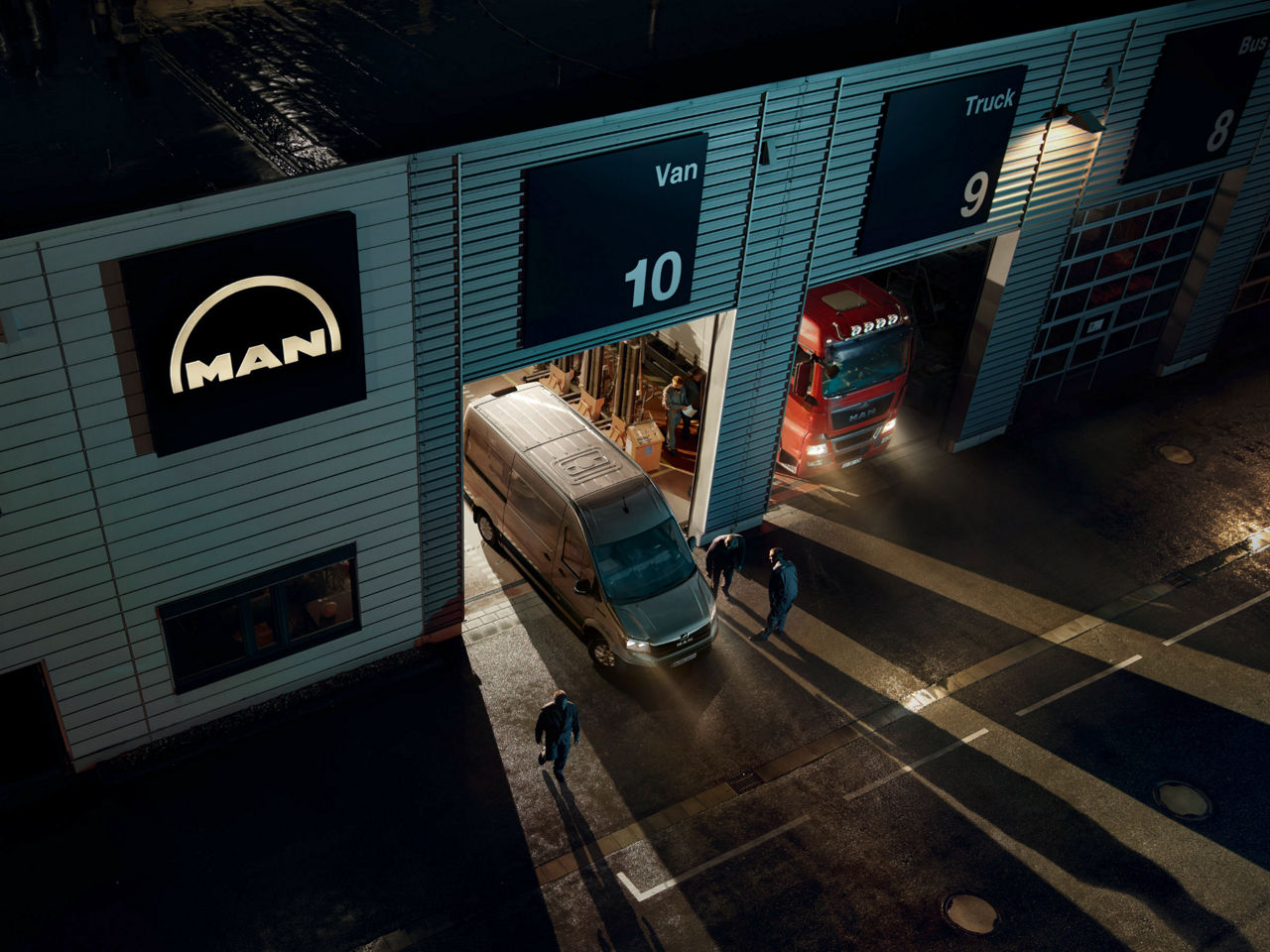 A van from MAN drives out of a workshop