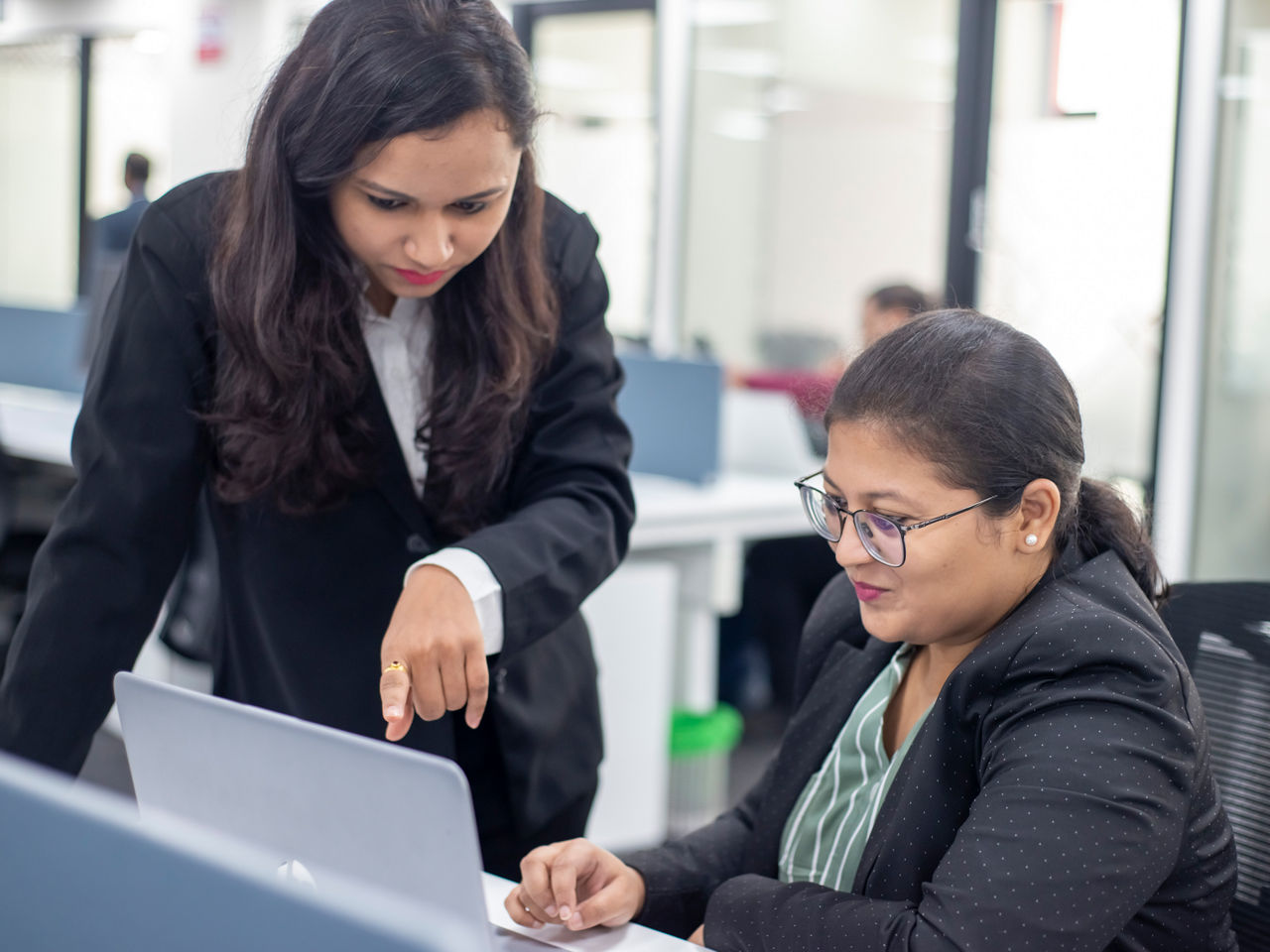 Two women are looking at a document 