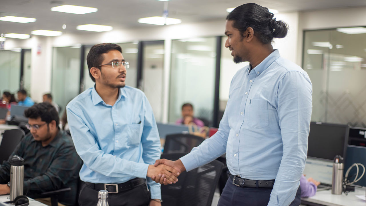 Two engineers shake hands 