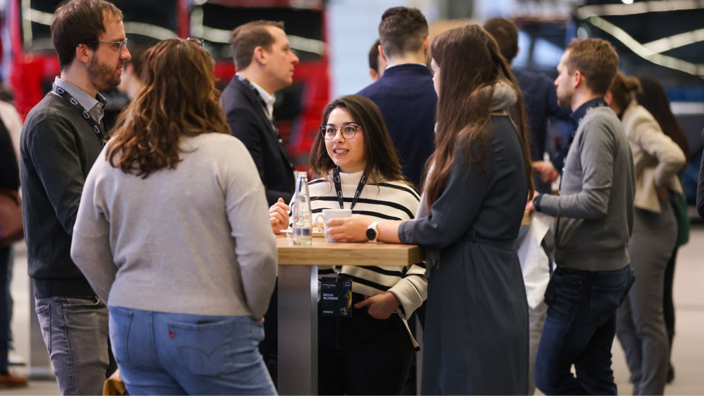 Several people standing around a table