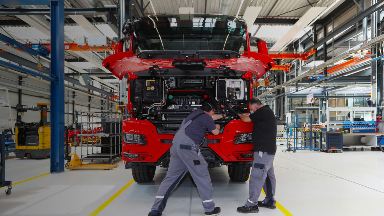 Two men working on a vehicle