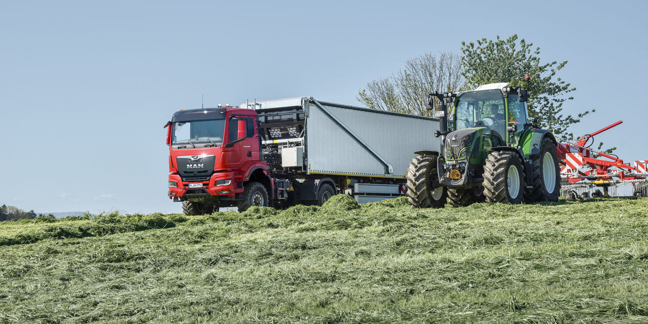 MAN trucks with soil-conserving tyres in agricultural use.