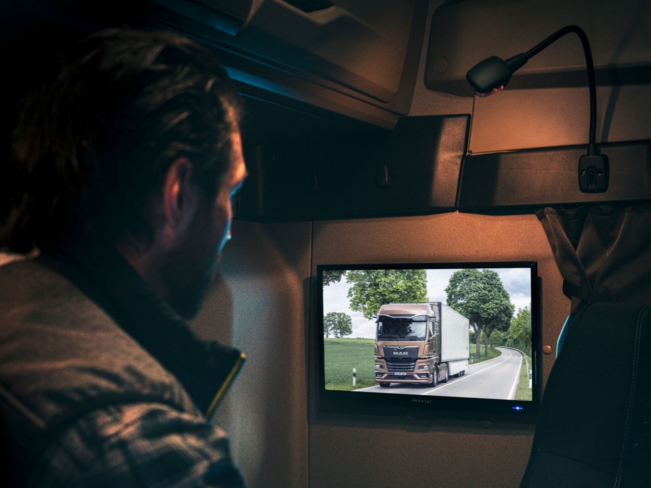 A driver watches television in his MAN truck.