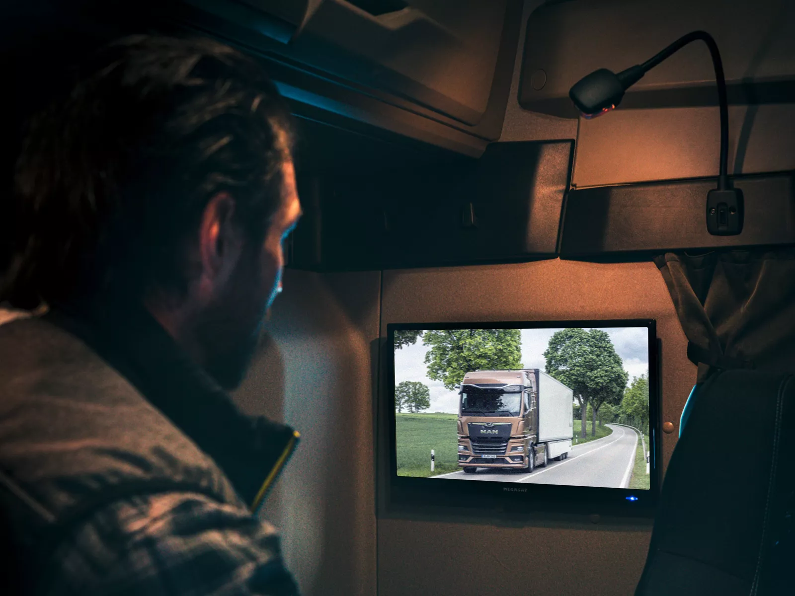 A driver watches television in his MAN truck.