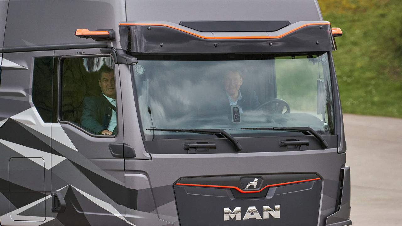 Dr Markus Söder and Alexander Vlaskamp in the cockpit of a truck. 