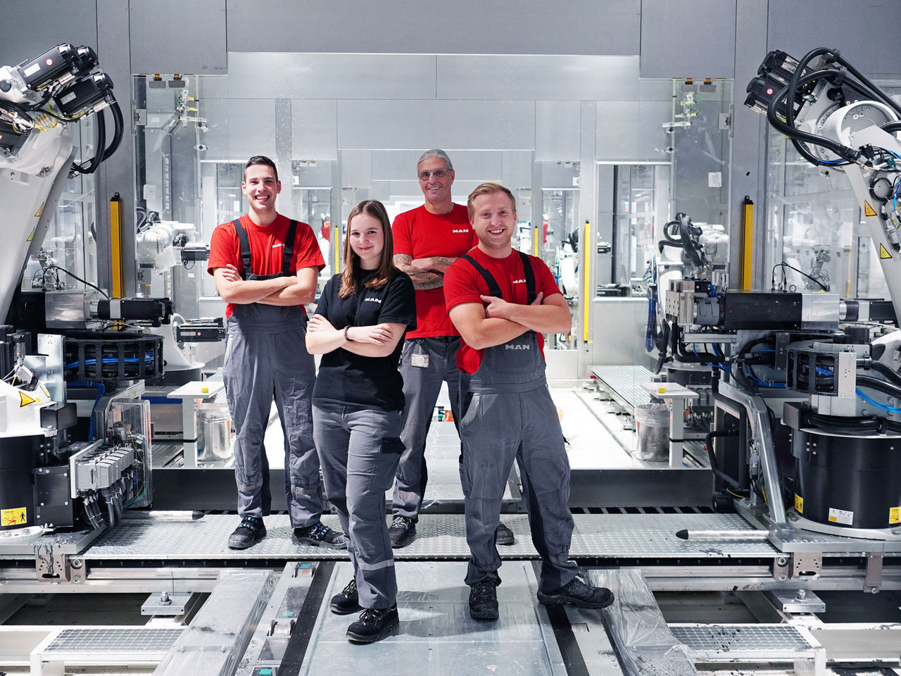 Employees of the maintenance team between machines in a MAN factory hall in Munich