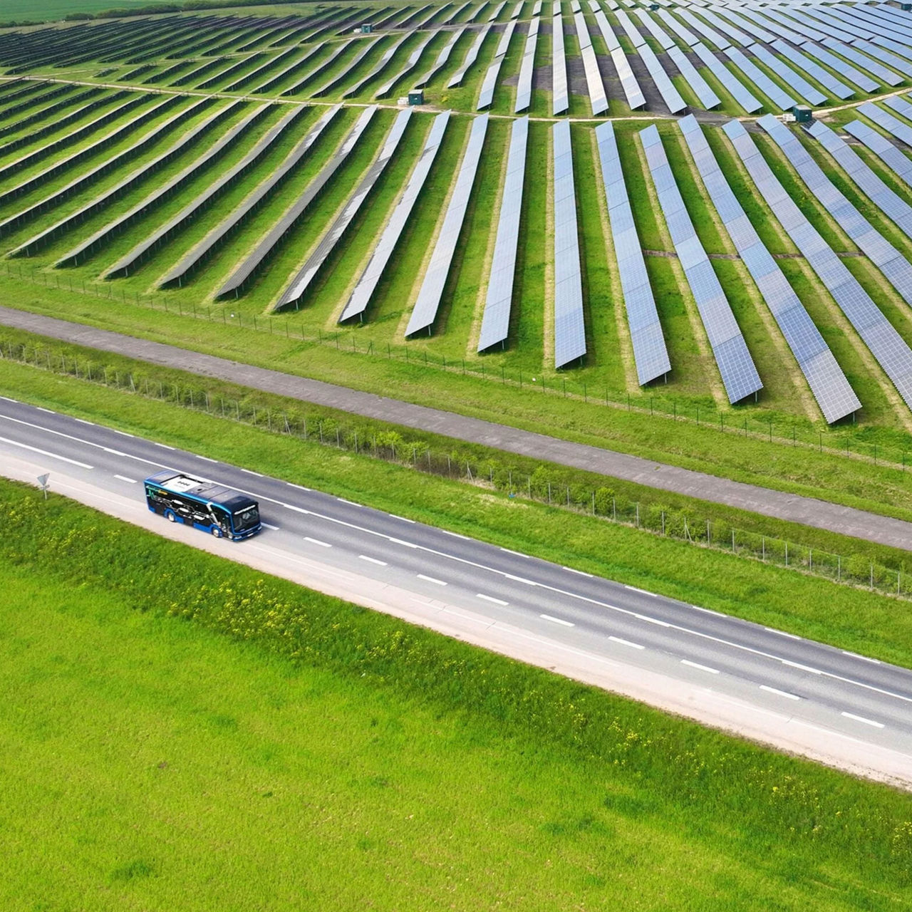 Electric MAN Lion’s City E on a road next to a solar field