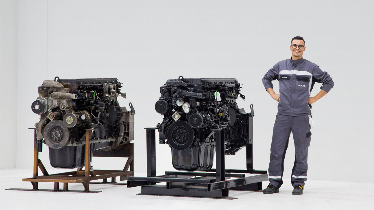 MAN employee presents an old and a reconditioned engine. 
