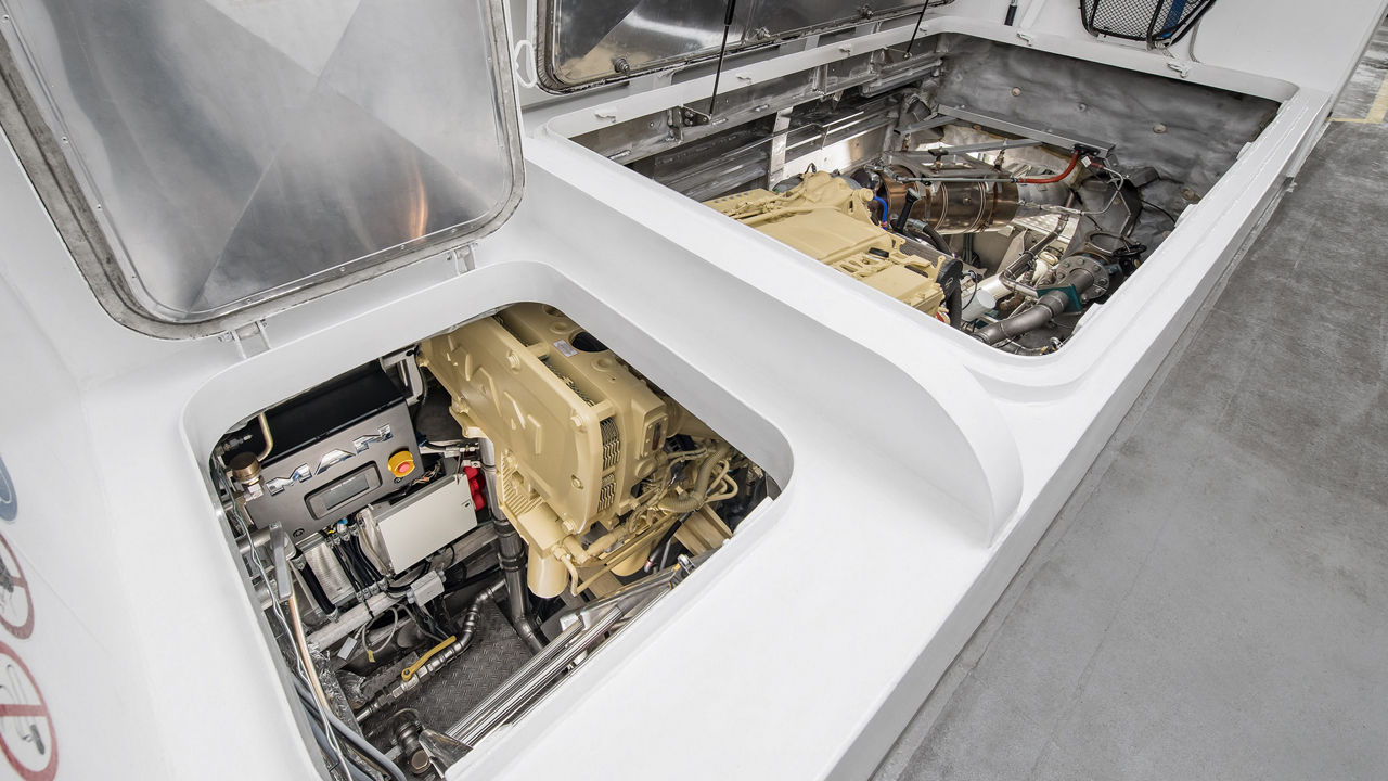 Blick durch zwei Klappen in den Motorraum eines Katamaran. 