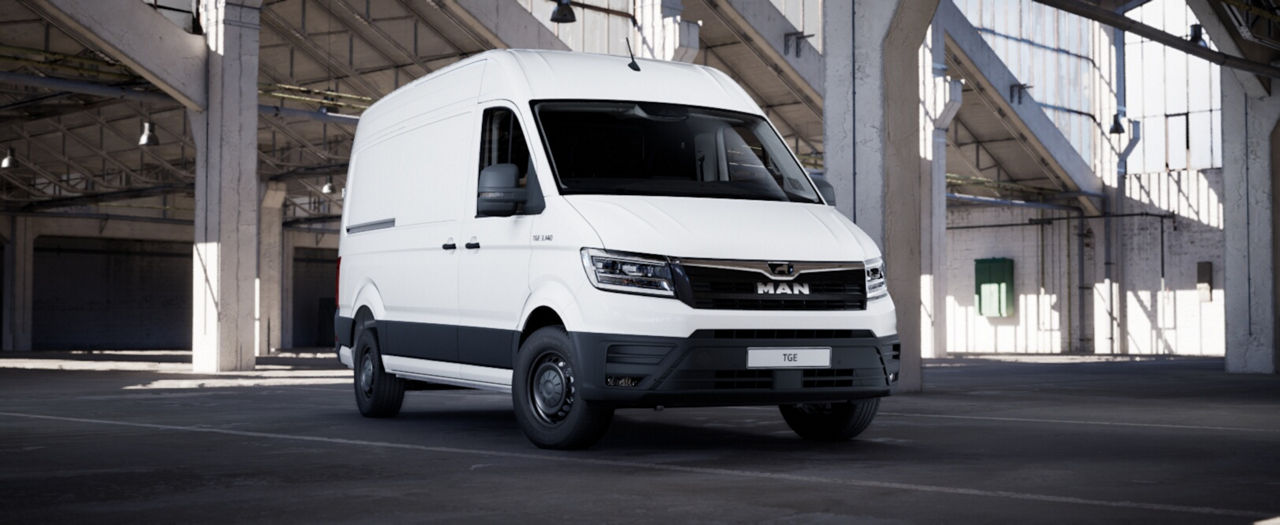 White MAN cargo van shown from front three-quarter angle inside an industrial warehouse.”